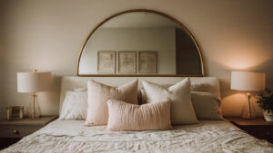 arched mirror above bed bedroom gold frame centered