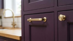 "brass cabinet pulls on aubergine purple kitchen cabinets"